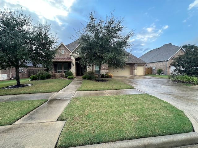 view of front of house featuring a garage and a front yard