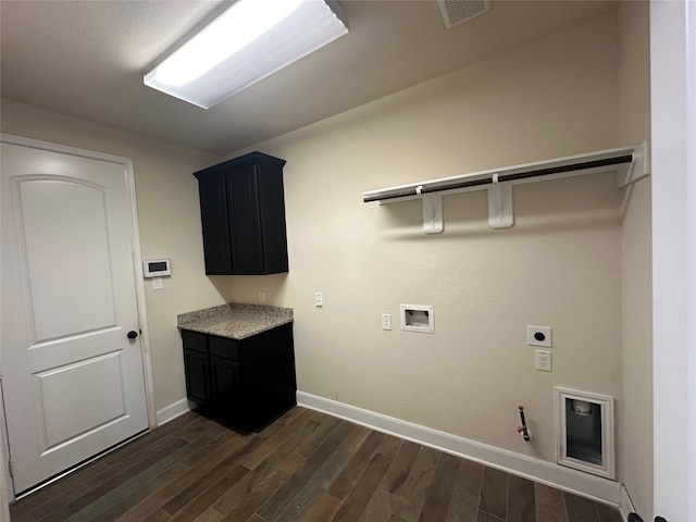 washroom with dark wood-type flooring, hookup for a washing machine, electric dryer hookup, and hookup for a gas dryer