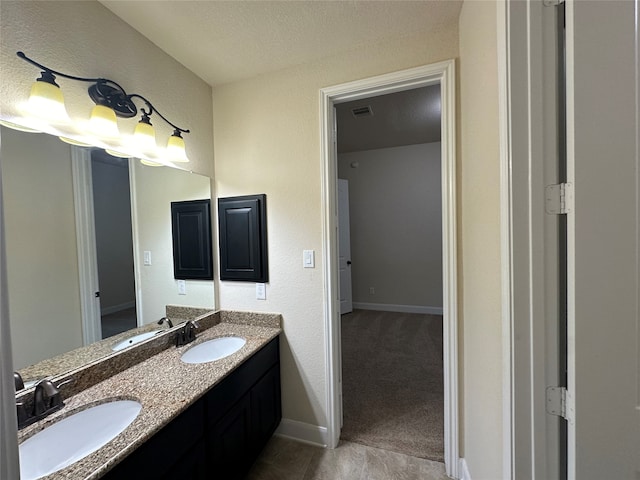 bathroom featuring vanity and a textured ceiling