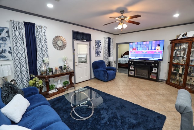 living room with ornamental molding, light tile patterned floors, and ceiling fan