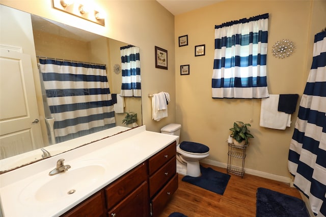 bathroom featuring vanity, toilet, and hardwood / wood-style floors