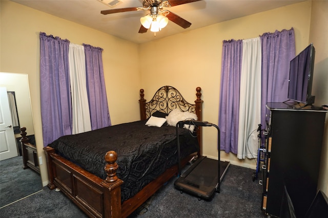 bedroom with ceiling fan and dark carpet