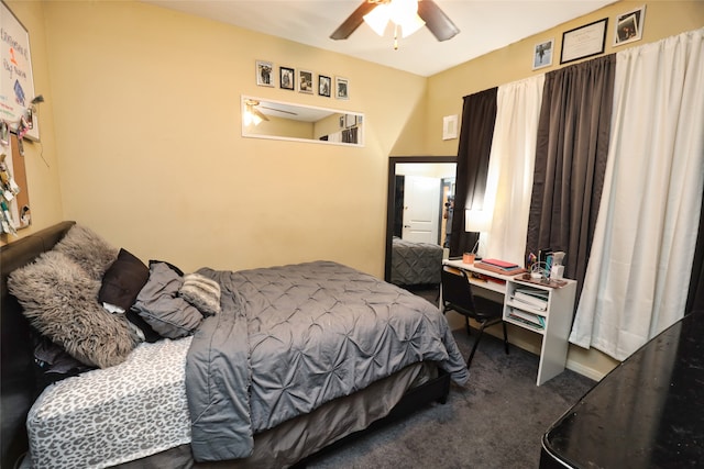 bedroom with dark colored carpet and ceiling fan