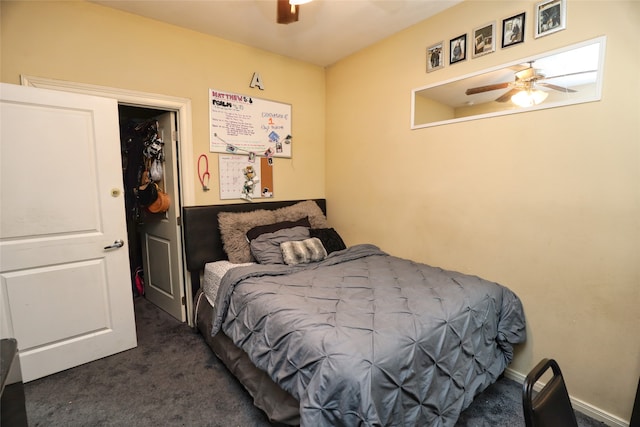 bedroom with a closet, ceiling fan, and dark colored carpet