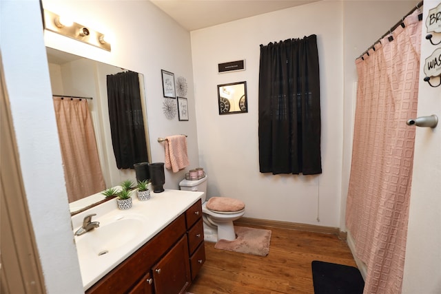 bathroom with vanity, hardwood / wood-style flooring, and toilet