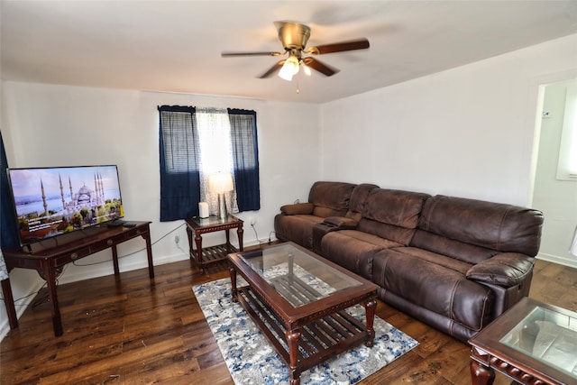 living room with dark wood-type flooring and ceiling fan