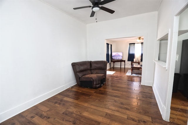 living area featuring dark hardwood / wood-style floors and ceiling fan