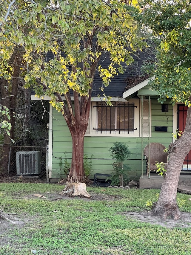 view of home's exterior with central AC unit and a yard