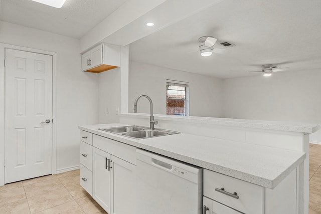 kitchen with white dishwasher, white cabinets, light tile patterned floors, sink, and ceiling fan