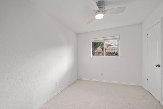 empty room with light carpet and ceiling fan