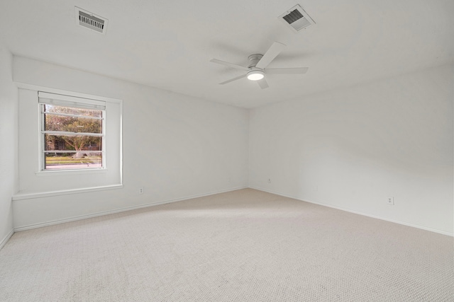 empty room with light colored carpet and ceiling fan