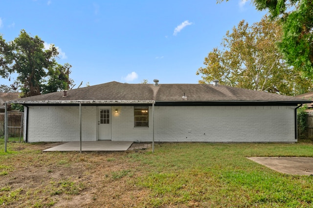 back of house featuring a lawn and a patio