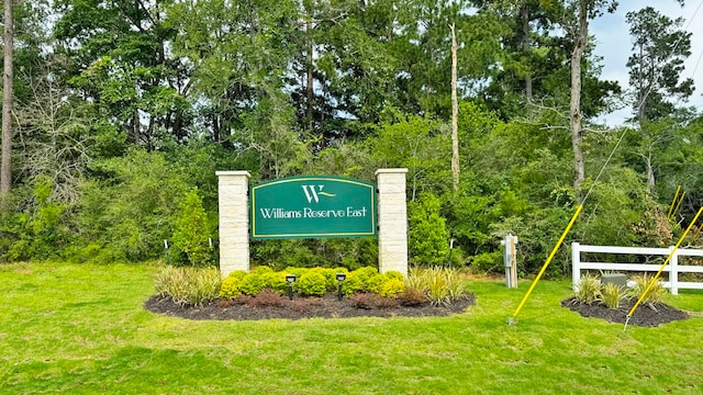 community sign featuring a yard