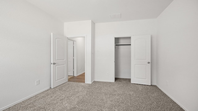 unfurnished bedroom featuring carpet and a closet