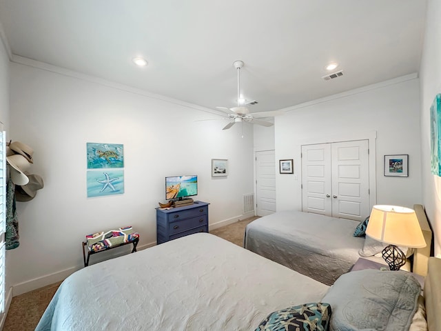 carpeted bedroom with ornamental molding, a closet, and ceiling fan