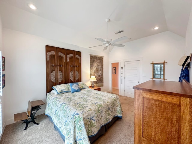 bedroom with ceiling fan, lofted ceiling, and light colored carpet