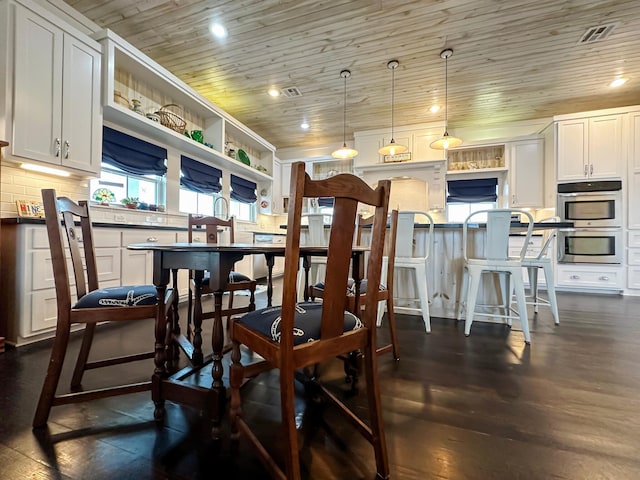 dining room featuring dark wood-type flooring and wood ceiling