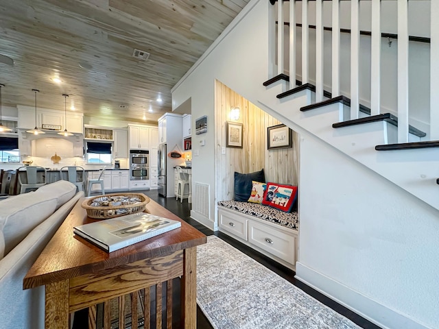 living room featuring dark wood-type flooring and crown molding