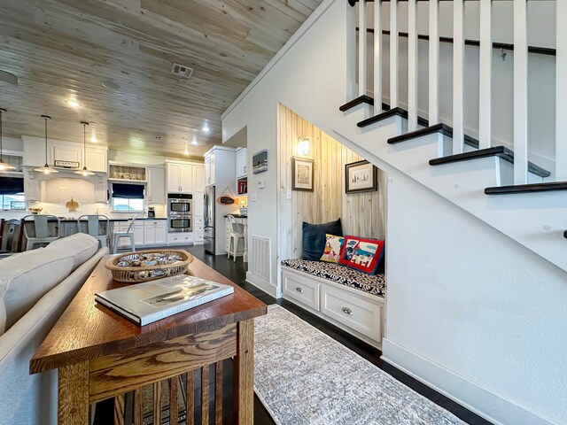 214 Biloxi, Crystal Beach, TX 77650 - living room featuring dark wood-style flooring, stairway, and wooden ceiling