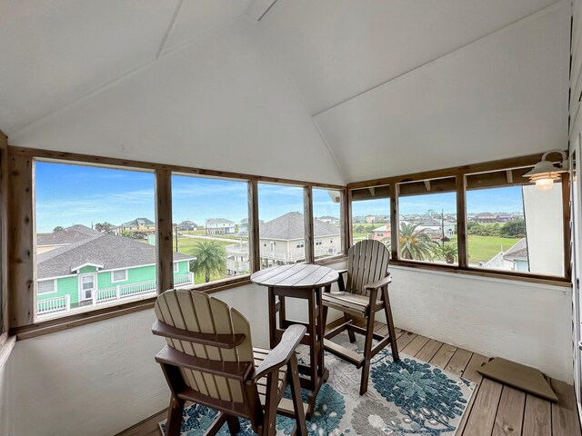 214 Biloxi, Crystal Beach, TX 77650 - sunroom / solarium with vaulted ceiling, wood-type flooring, and a residential view