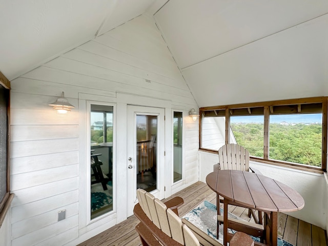 sunroom with lofted ceiling and a healthy amount of sunlight