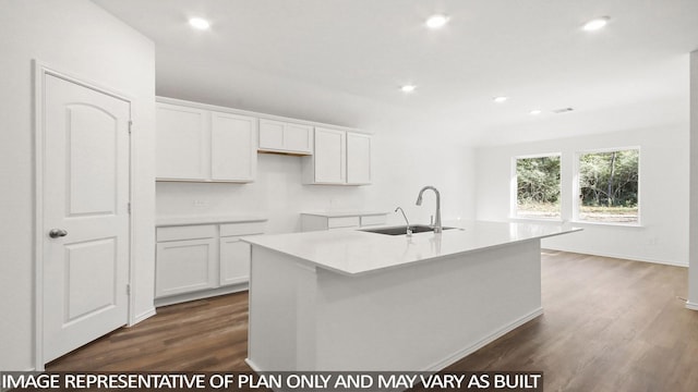 kitchen featuring white cabinetry, sink, dark hardwood / wood-style flooring, and an island with sink