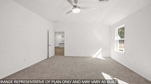 carpeted empty room featuring vaulted ceiling and ceiling fan