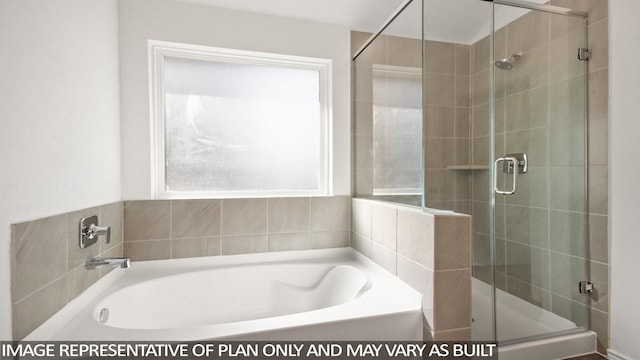 bathroom featuring separate shower and tub