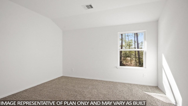 carpeted spare room with lofted ceiling