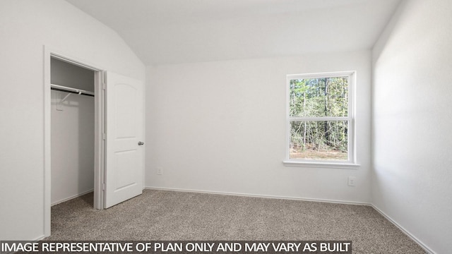 unfurnished bedroom with lofted ceiling and carpet