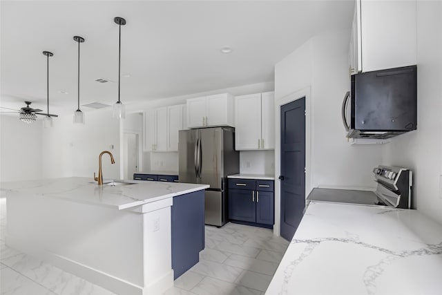 kitchen with white cabinetry, stainless steel appliances, decorative light fixtures, and an island with sink