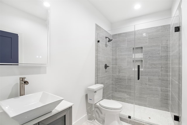 bathroom with an enclosed shower, vanity, tile patterned floors, and toilet