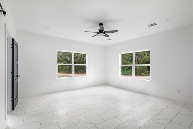 unfurnished room featuring plenty of natural light and ceiling fan