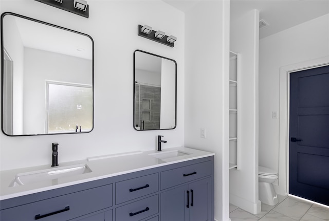 bathroom featuring vanity, toilet, and a shower with door