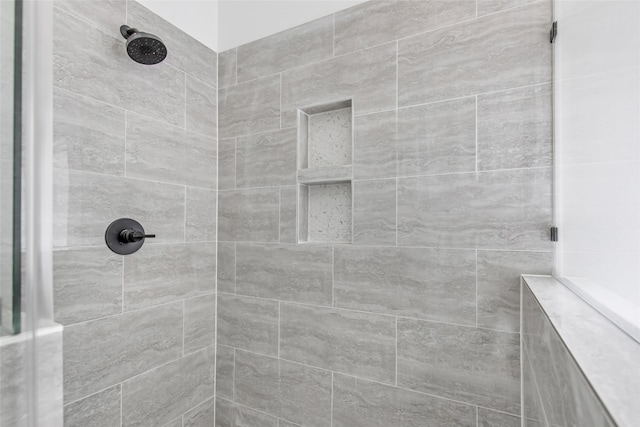 bathroom with a tile shower