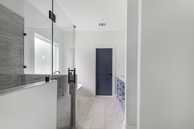 bathroom with vanity and independent shower and bath