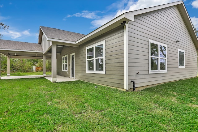 rear view of house featuring a patio area and a yard