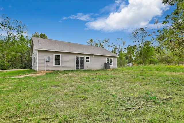 back of house with a lawn