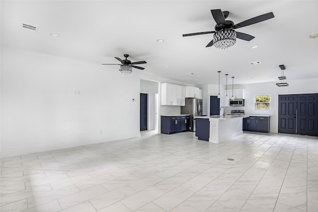 unfurnished living room featuring sink and ceiling fan