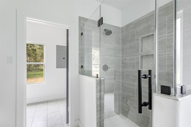 bathroom featuring electric panel and a shower with shower door