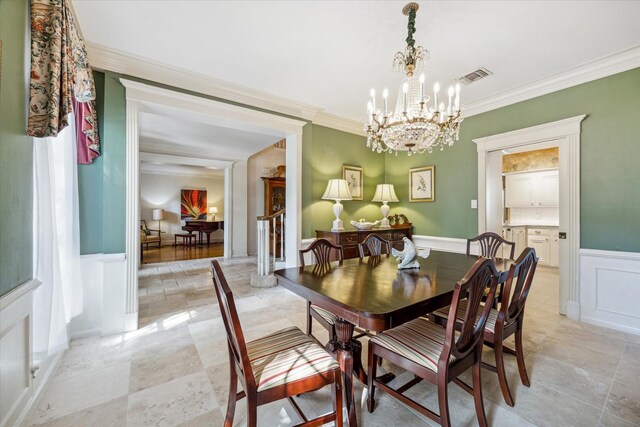 dining area featuring ornamental molding and a chandelier