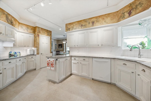 kitchen featuring white dishwasher, sink, kitchen peninsula, decorative backsplash, and white cabinetry