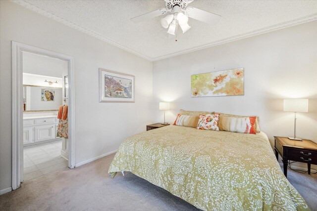 carpeted bedroom with connected bathroom, ceiling fan, a textured ceiling, and ornamental molding