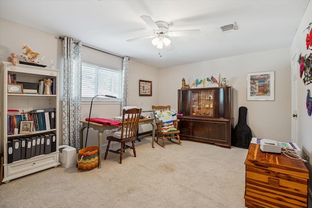 carpeted office space with ceiling fan