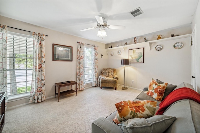 living room with ceiling fan and light colored carpet