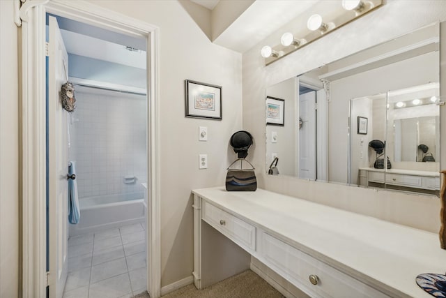 bathroom featuring tile patterned flooring, vanity, and tiled shower / bath