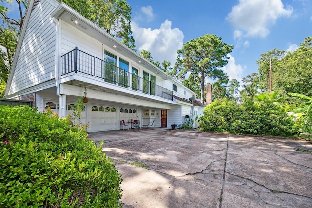 exterior space featuring a balcony and a garage