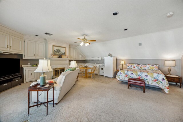 carpeted bedroom featuring ceiling fan, white refrigerator, and vaulted ceiling