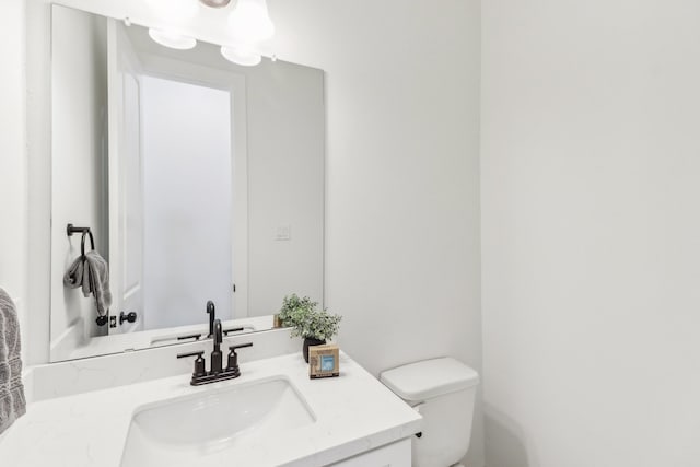 bathroom with toilet and vanity