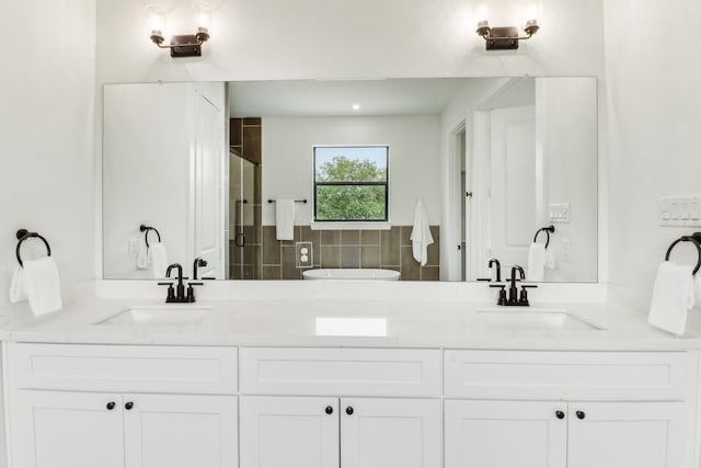 bathroom with a shower with door, vanity, and decorative backsplash